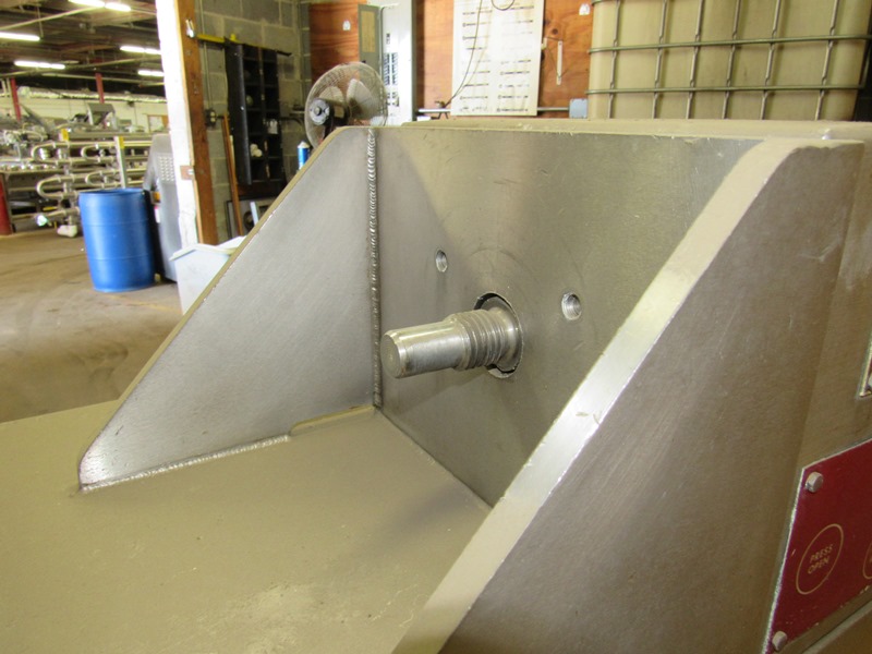 A stainless meat press